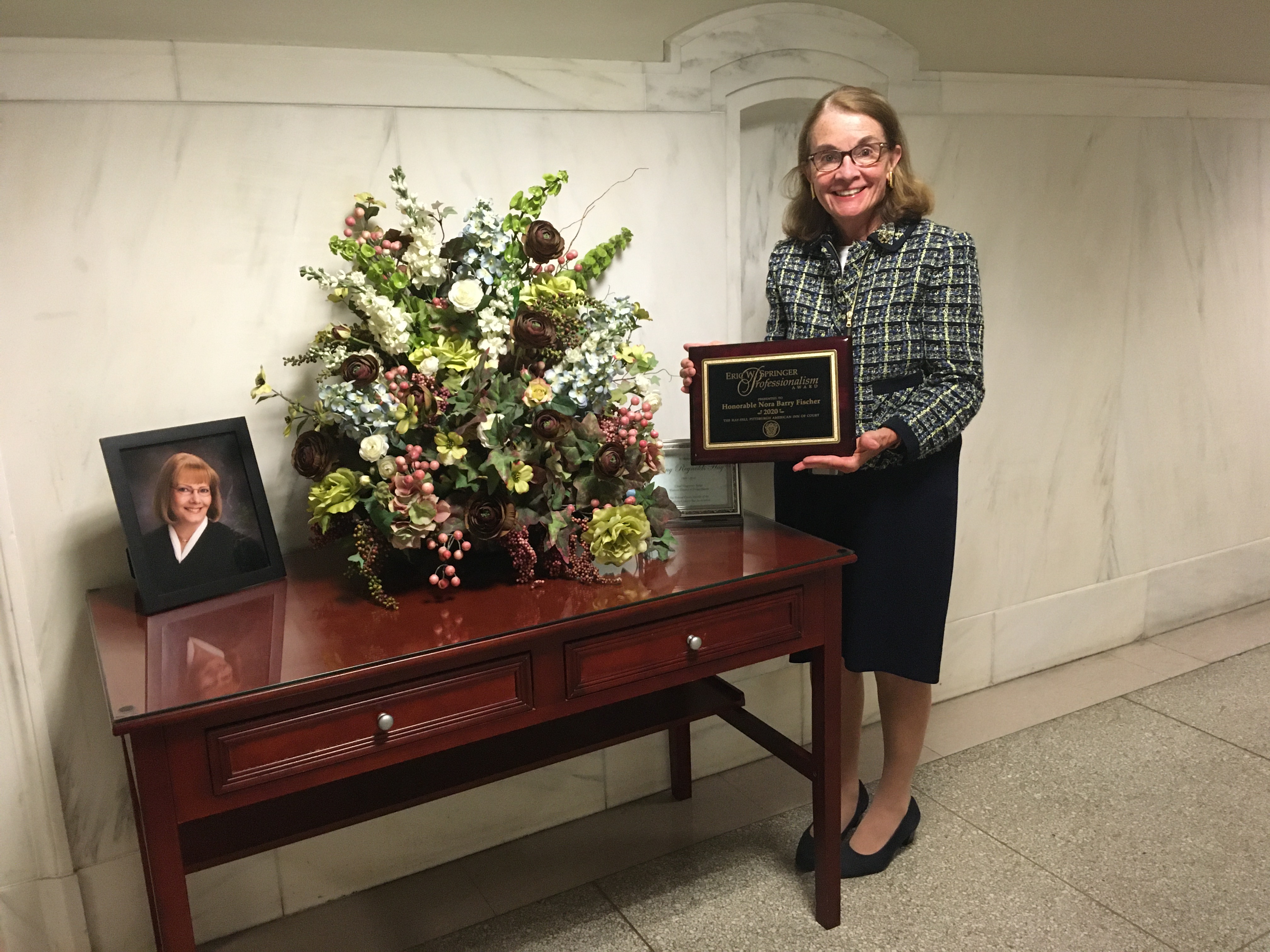 The Hay-Sell Pittsburgh American Inn of Court presented The Honorable Nora Barry Fischer with the Eric W. Springer Professionalism Award for 2020 in July at the U.S. District Court for the Western District of Pennsylvania.  The Springer Award was created to honor Eric W. Springer, who in 2006 was the former W. Edward Sell American Inn of Court’s first recipient of the American Inns of Court Professionalism Award for the Third Circuit. The award honors a member of the Hay-Sell Inn whose life and practice display sterling character, unquestioned integrity, and an ongoing dedication to the highest standards of the legal profession and the rule of law.   Judge Fischer, a Master of the Bench in the Inn and its Counselor, was recognized for inspiring and improving the legal profession by promoting the highest standards of ethics, civility, and professionalism, and by giving back to the profession by mentoring young lawyers and law students.  Fischer chose to be presented with the award at the memorial set up to honor the late Amy Reynolds Hay, U.S. Magistrate Judge, a friend who recruited Fischer to the Inn and for whom the Hay-Sell Pittsburgh American Inn of Court also is co-named.