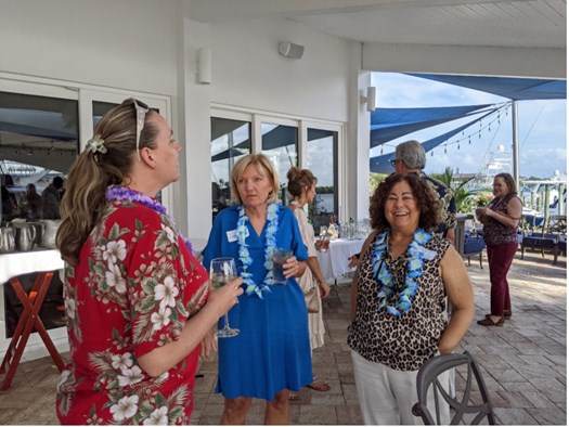 Ruth Singer, Judge Jennifer Taylor, and Judge Michelle Vitt Baker chat at the luau