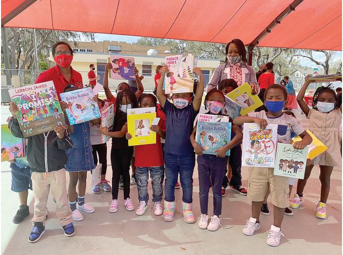 Picture of students holding donated books
